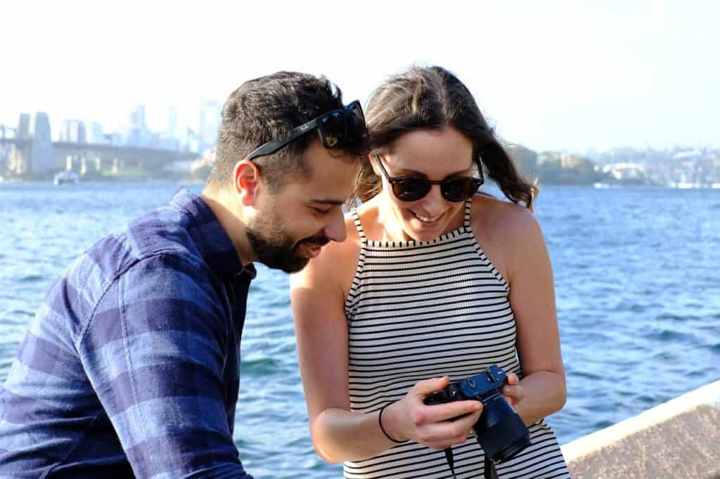 Man and woman looking at phone pictures