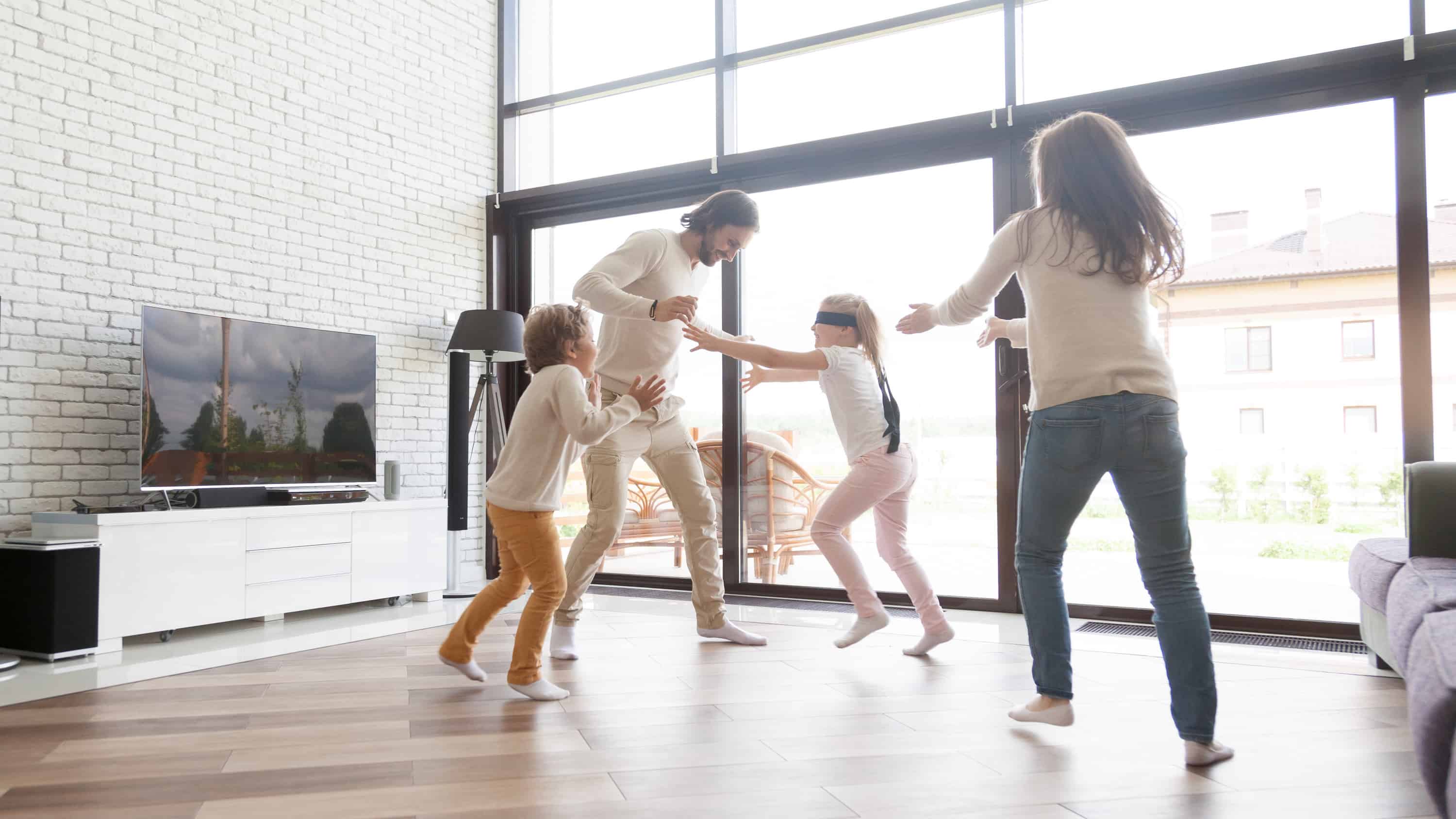 married couple actively playing with two children