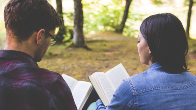 two teens sitting and studying