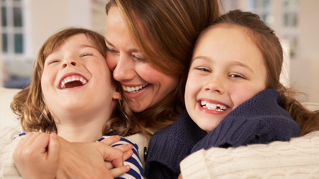 Mother hugging her son and daughter, affirming her sexual identity