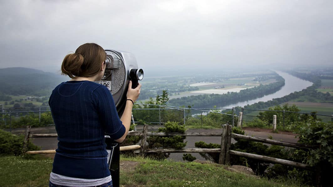 Woman looking through a quarter-activated binocular system