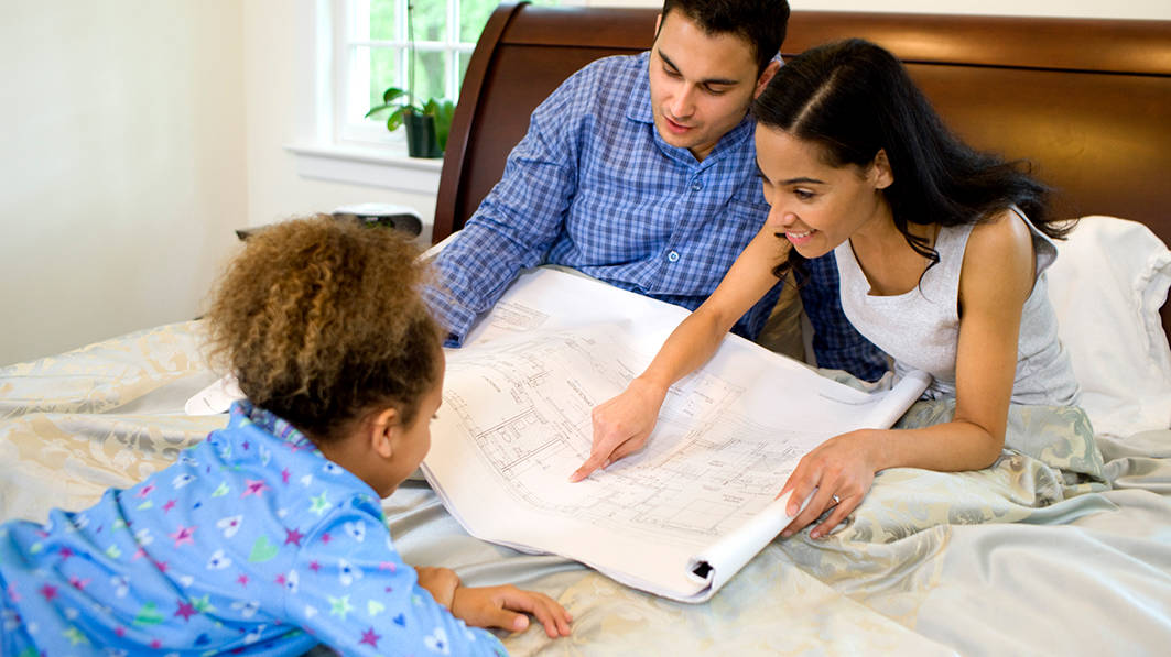 Family looking at blueprints