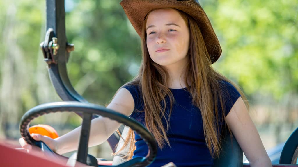 Farm Girl Driving a Tractor