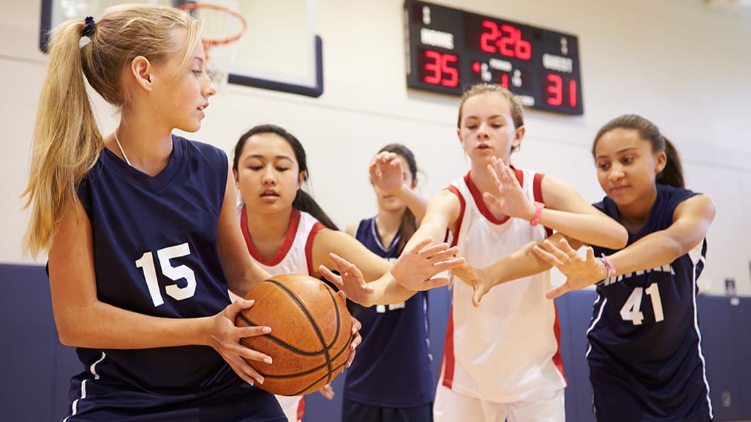 Snapshot from a basketball game between two teams of junior high girls