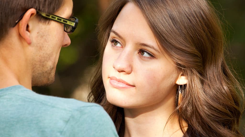 Woman looking at man during a conversation of faith