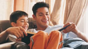 Father Reading to his Son, Sitting in an Armchair