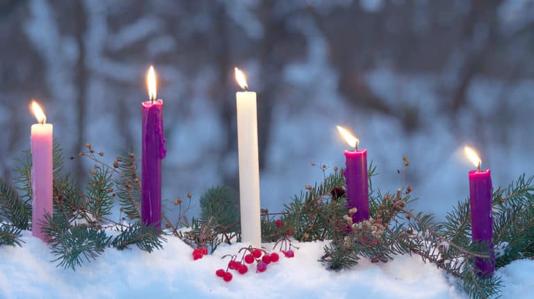Lit candles in the snow