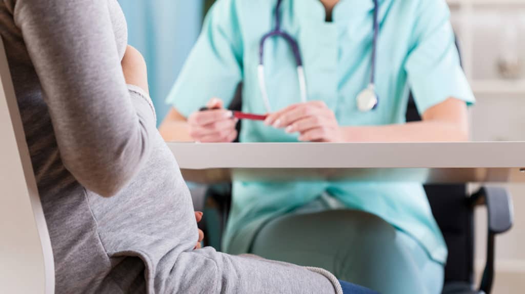 A female doctor counseling a pregnant woman