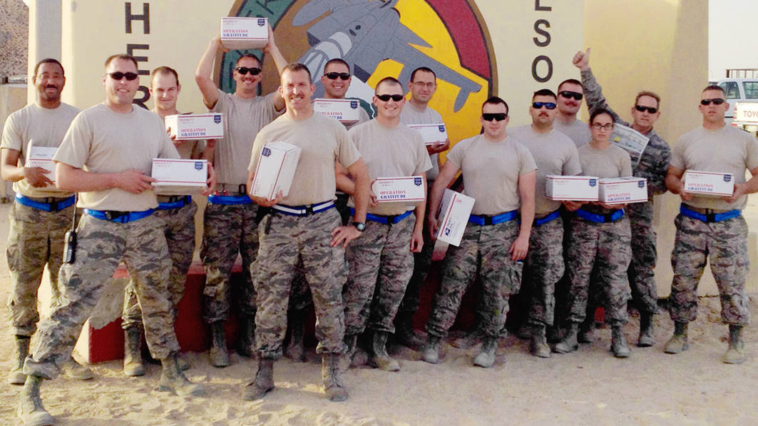 Honor and Support to our troops is seen as several service men and women are in the picture with packages that were sent to them.