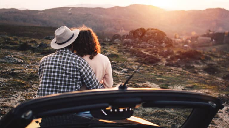 married couple watching sunset