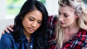 Woman comforting her sad friend