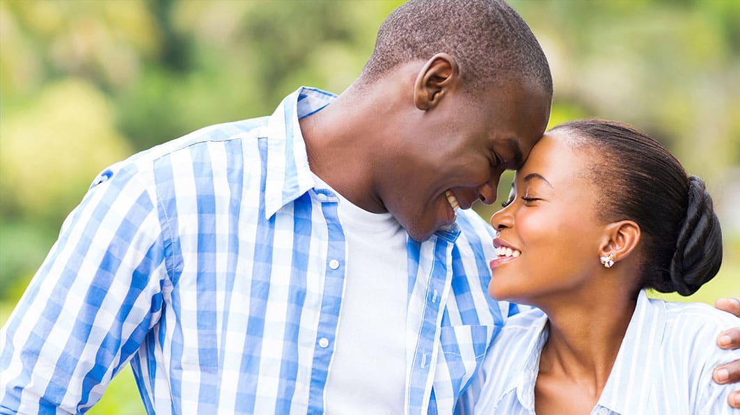 A man and a woman smiling at one another