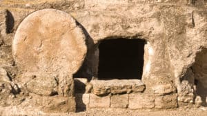 Close up view of the opening of Jesus Christ’s empty tomb, with the stone door rolled aside