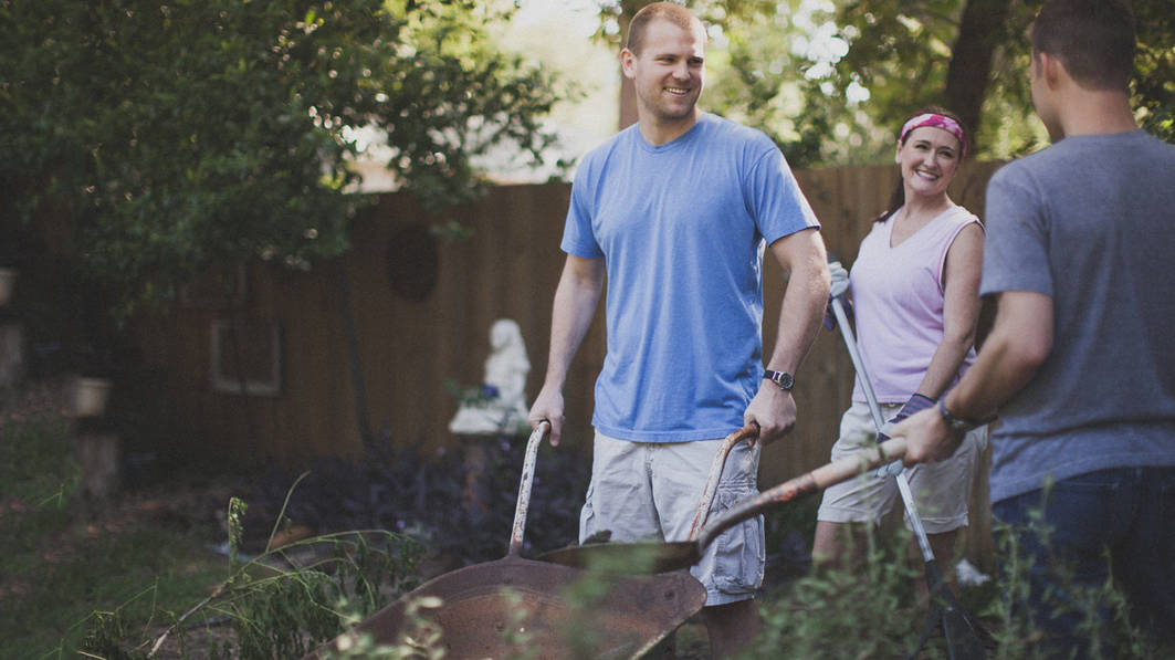 Two men and a woman doing yardwork