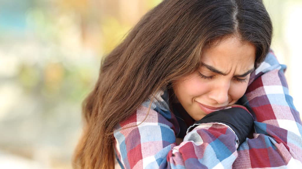 Living with healthy grief. Teen girl crying