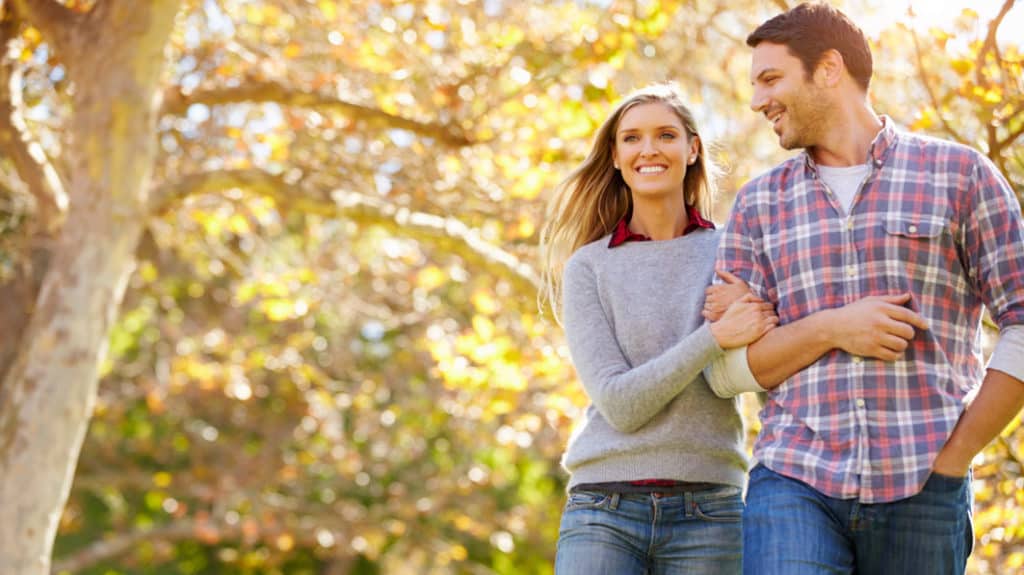 Happy couple walking outside during the Fall