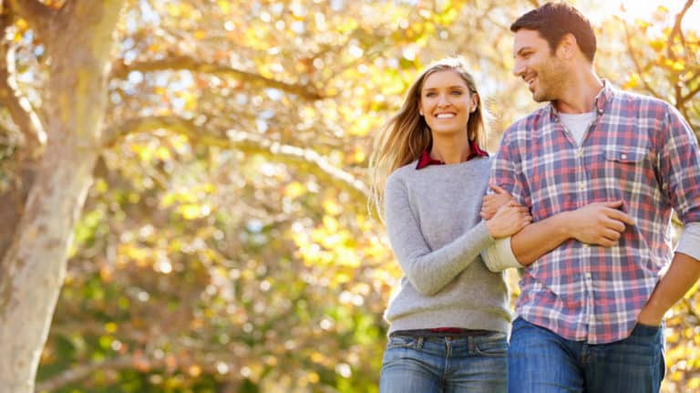 Happy couple walking outside during the Fall