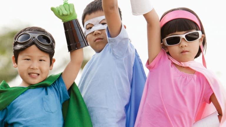 Three children dressed as unique superheroes