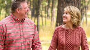 Jim and Jean Daly walking in the woods