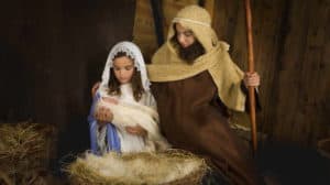 Kids playing Mary, Joseph & Jesus at the manger