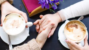 Couple in love holding hands in a cafe