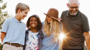 a multi-race family of four, outside with their dog