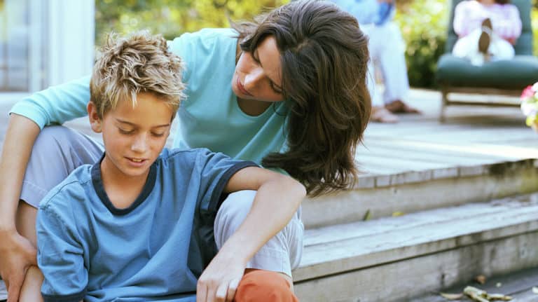 Mom consoles distressed son