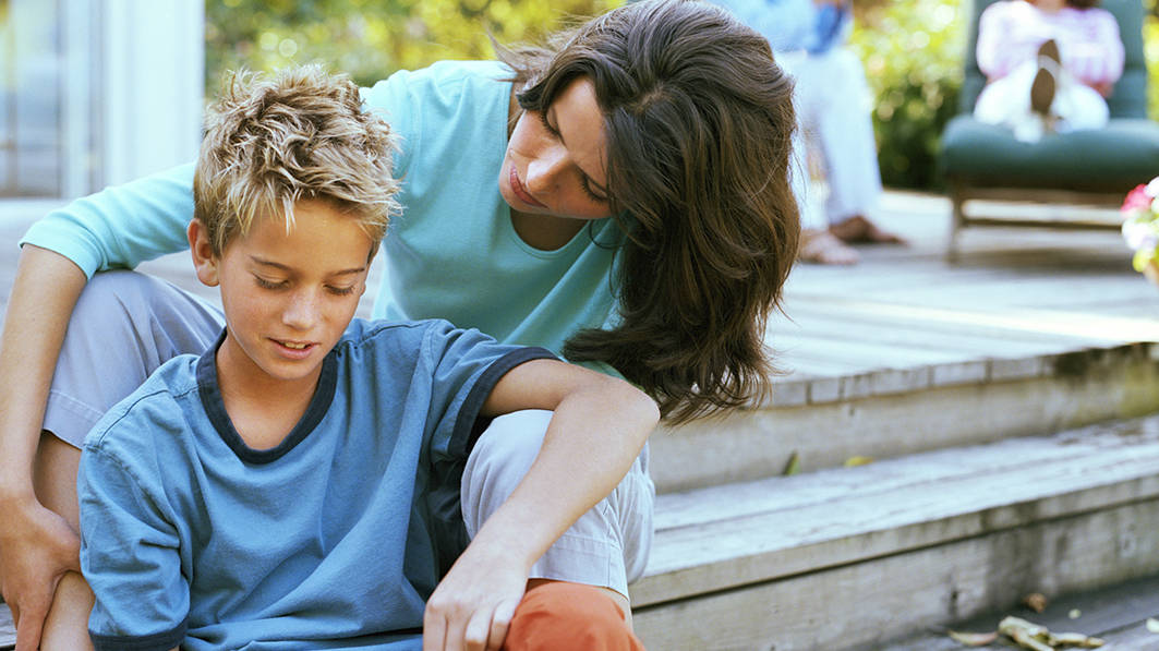 Mom consoles distressed son