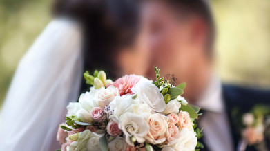 Newly married couple kisses