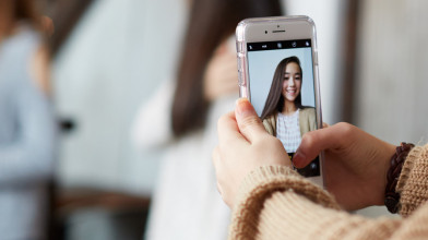 Picture of girl taking a selfie picture of herself.