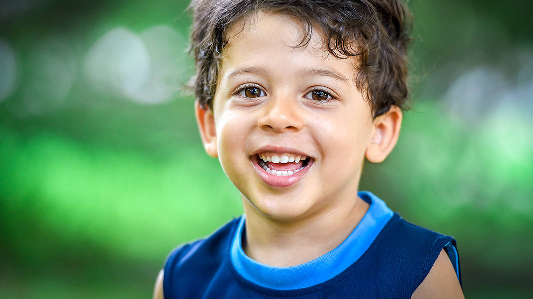 Happy young boy smiling