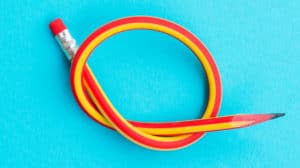 A flexible pencil is twisted into a knot.