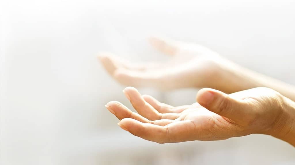 hands facing upward in prayer