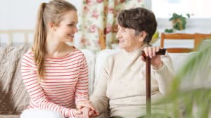 A young girl sits with her grandmother, trying to help herself in understanding dementia.