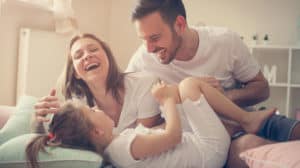 Mom and dad playing with daughter