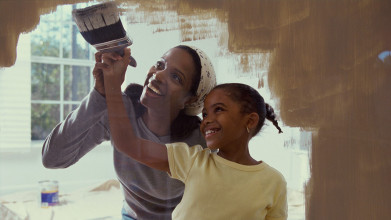 Mother and daugher painting a wall together
