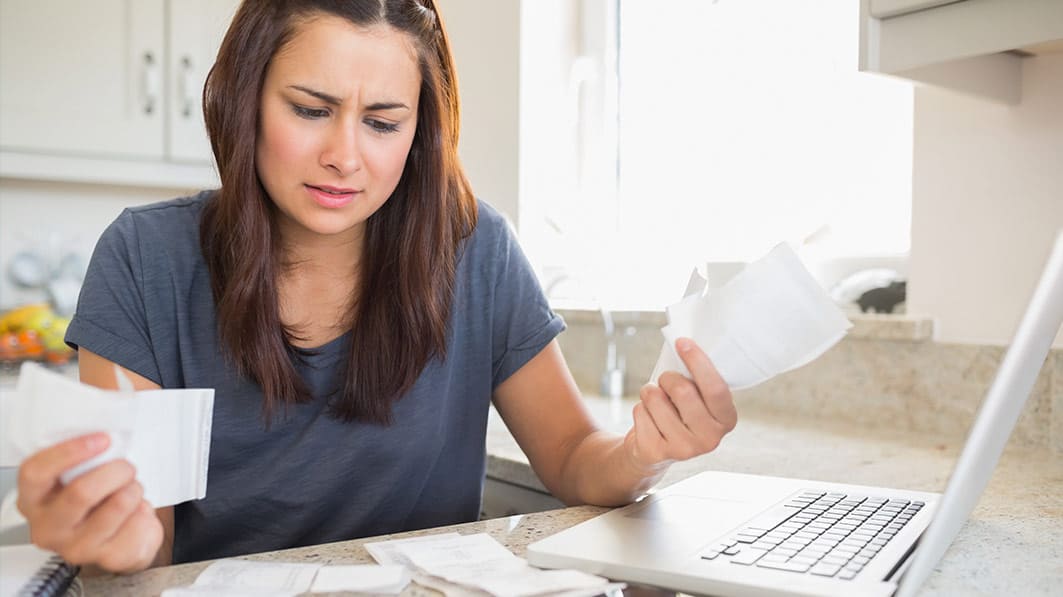 Single mom is frustrated as she tries to reconcile bills and receipts