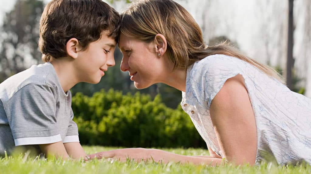 A mom looks into the eyes of her young son