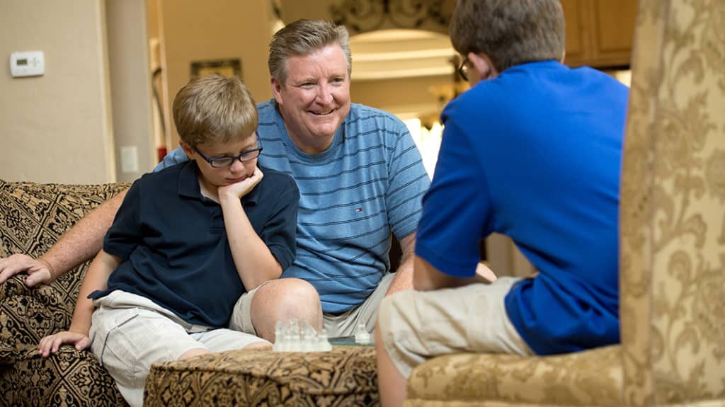Jim Daly playing chess with his sons