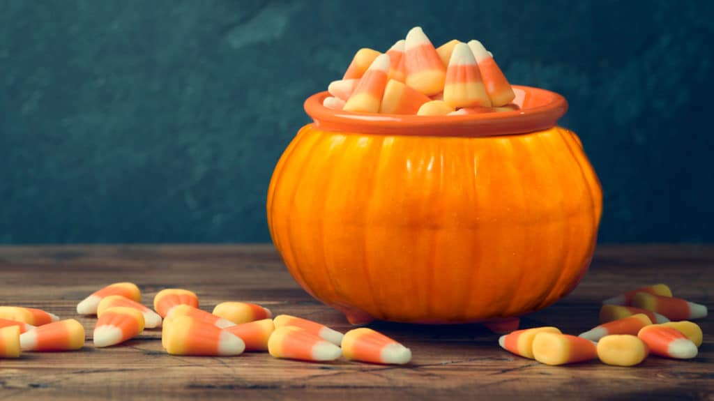 Candy corn in pumpkin shaped bowl