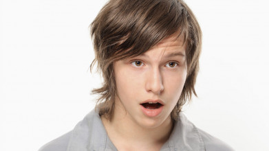 A jaw-dropped teen looks astonished with sexual attraction to something he has seen