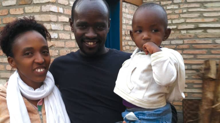 African-American couple holding their young child