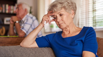 Unhappy senior couple, wife in foreground