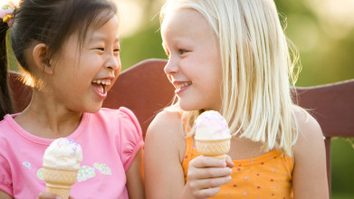 Two young girls enjoying ice cream cones