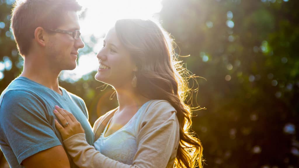 Young couple embracing outside