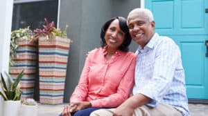 Elderly couple sitting together smiling