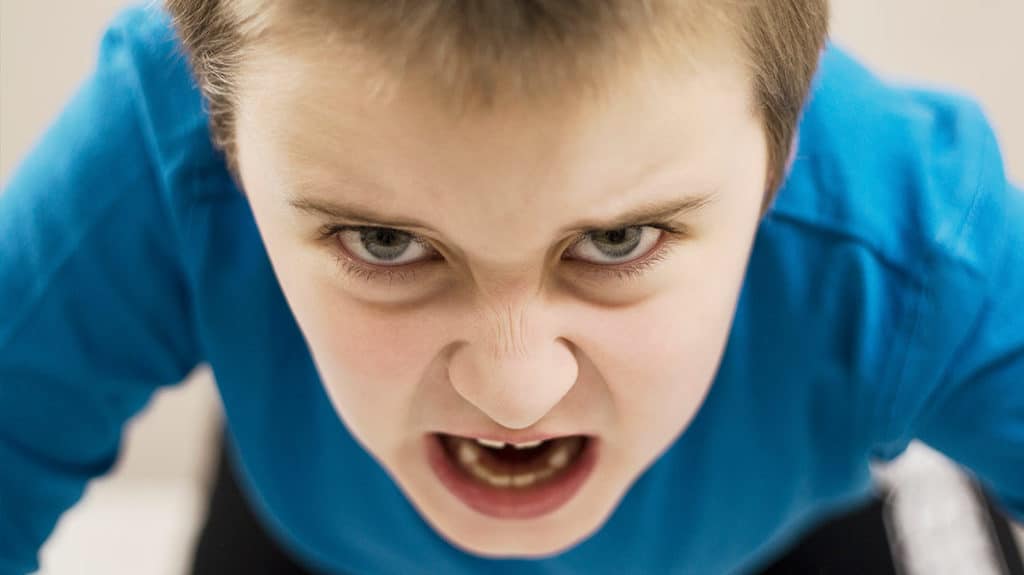 Close up of angry young boy's face