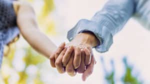 effects of marriage on health and happiness shown by couple holding hands