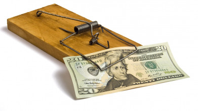Twenty dollar bill trapped in a mousetrap