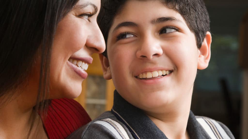 Close up of mom and son looking into each other's face and smiling